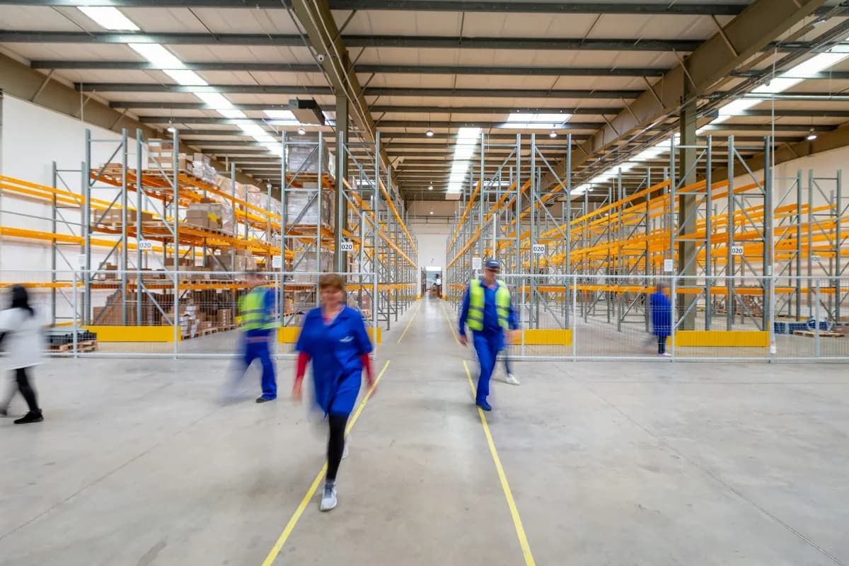 Team members walking together through a warehouse facility