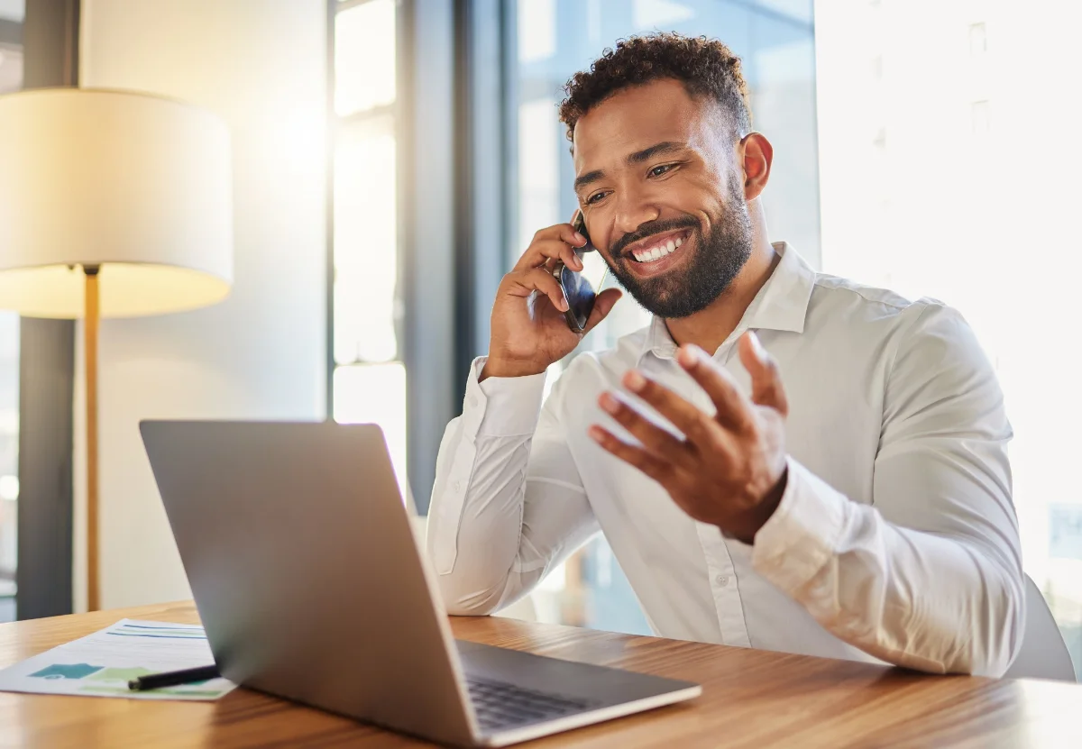 Client discussing a construction project on a phone call at a desk