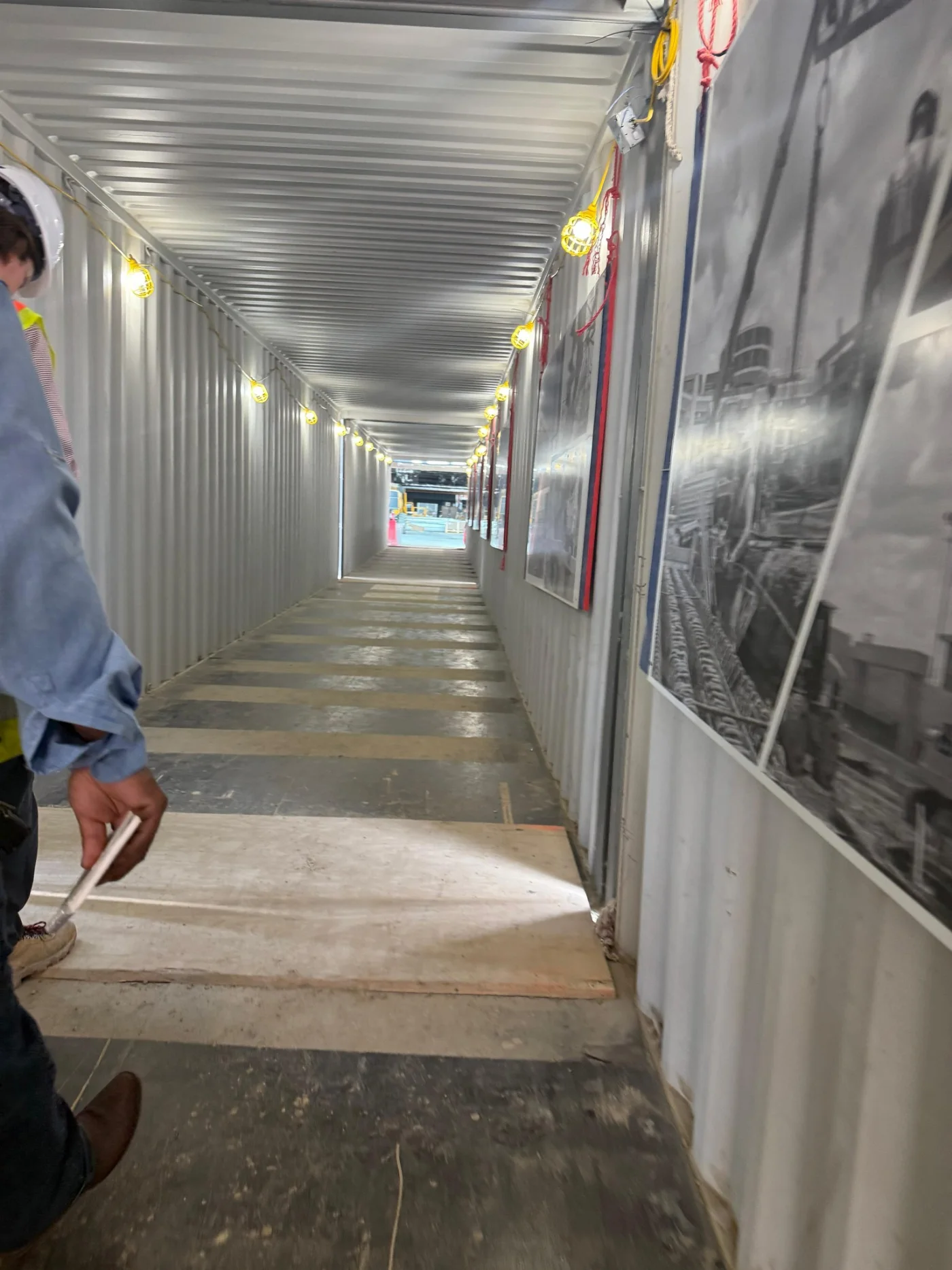 Interior corridor during finish-out with drywall taped and ready for paint
