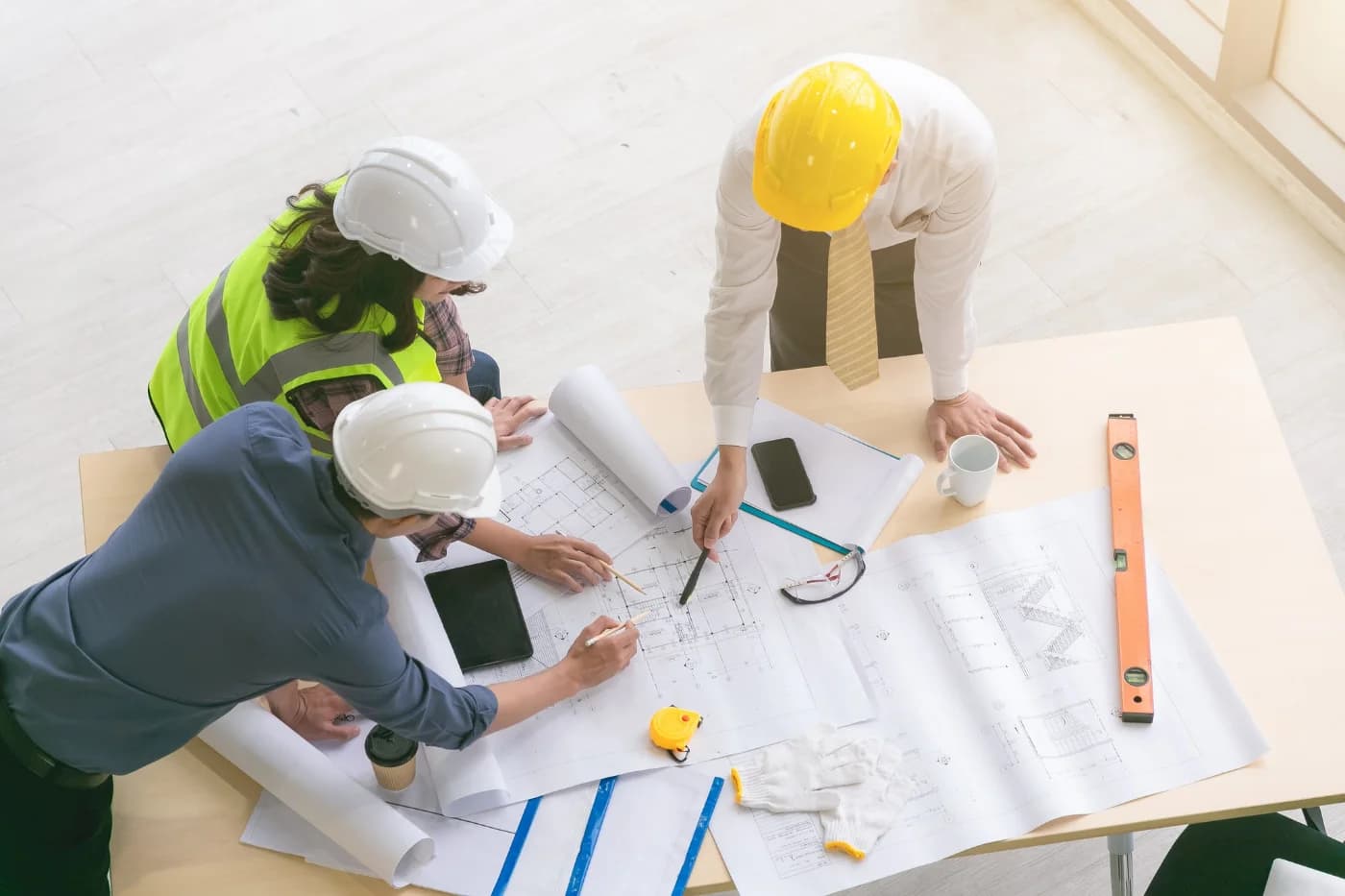 Construction team reviewing plans and coordinating work on site
