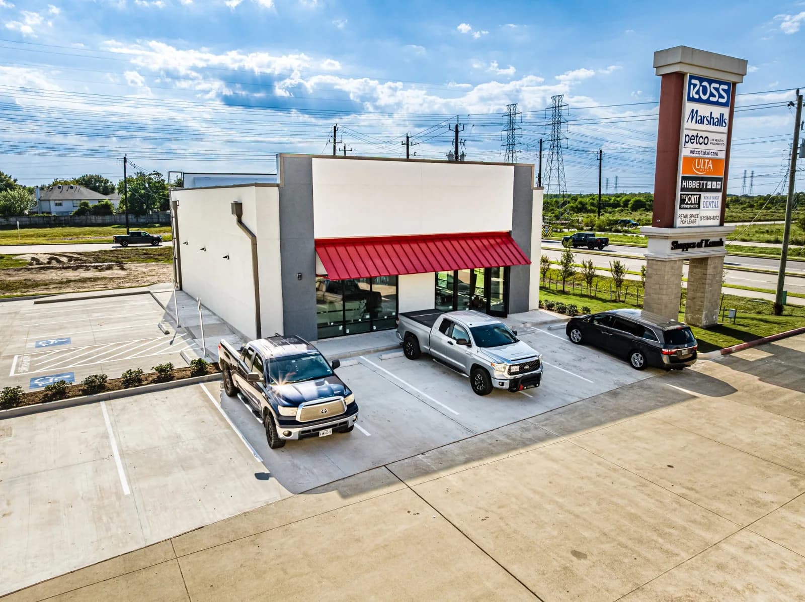 Completed Verizon store at Kemah, Texas with red canopy and customer parking