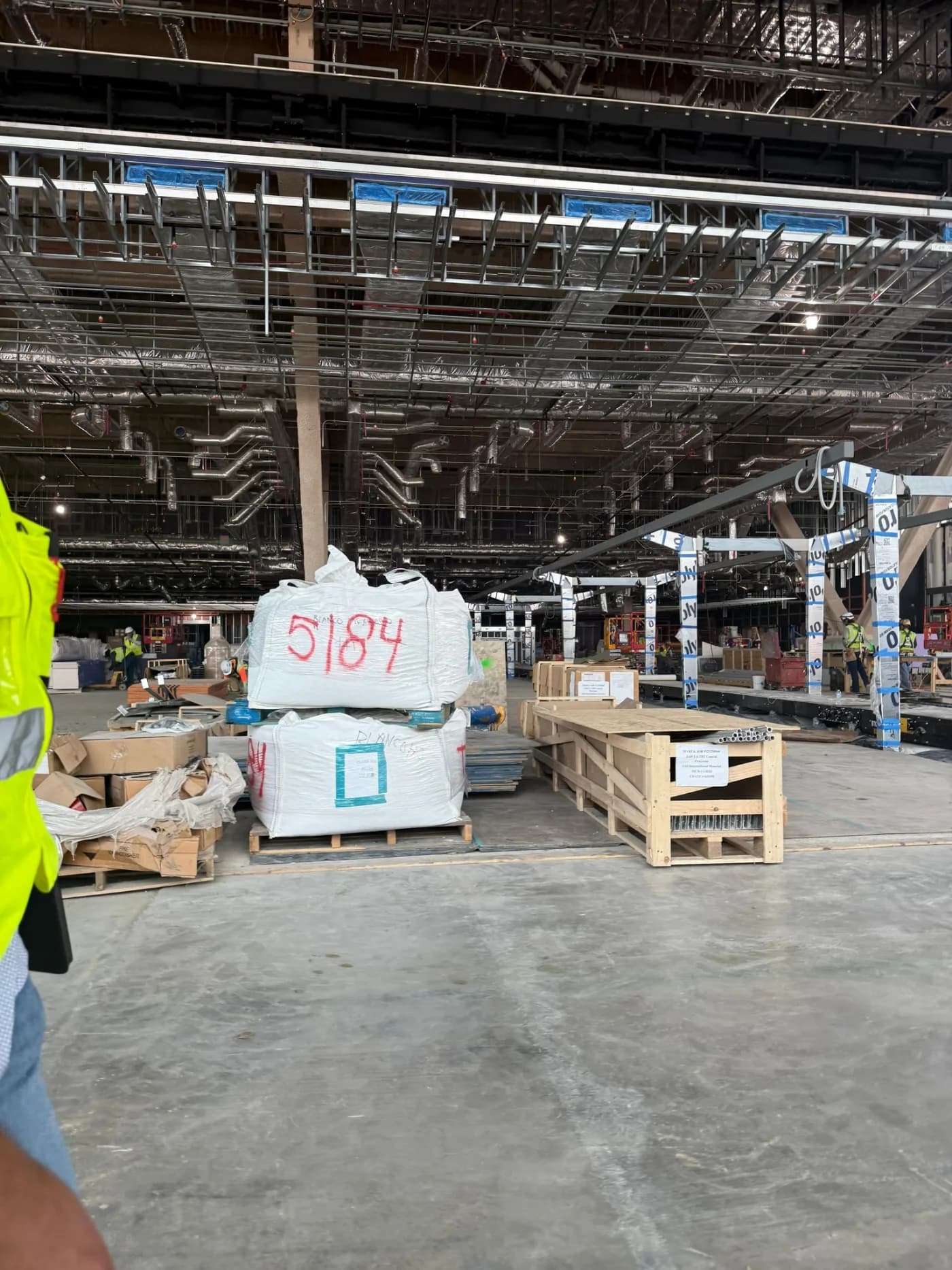 Materials staged inside a warehouse during an active construction project